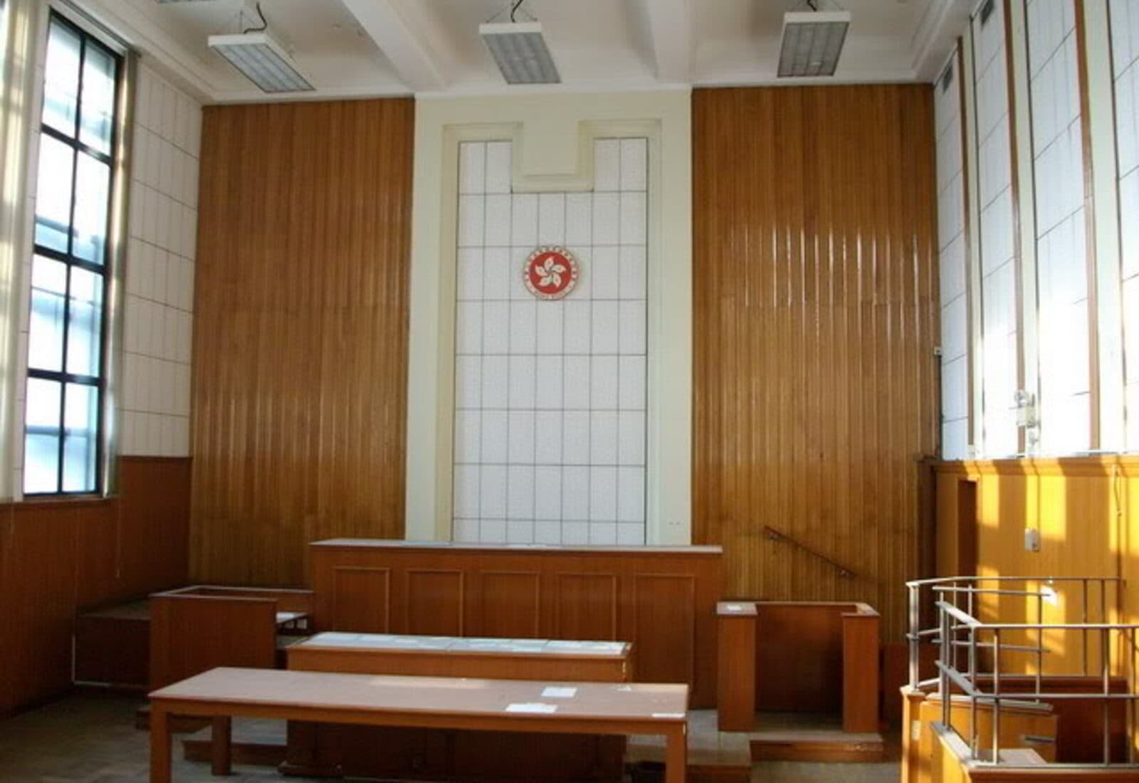Wood-paneled courtroom prepared for a hearing