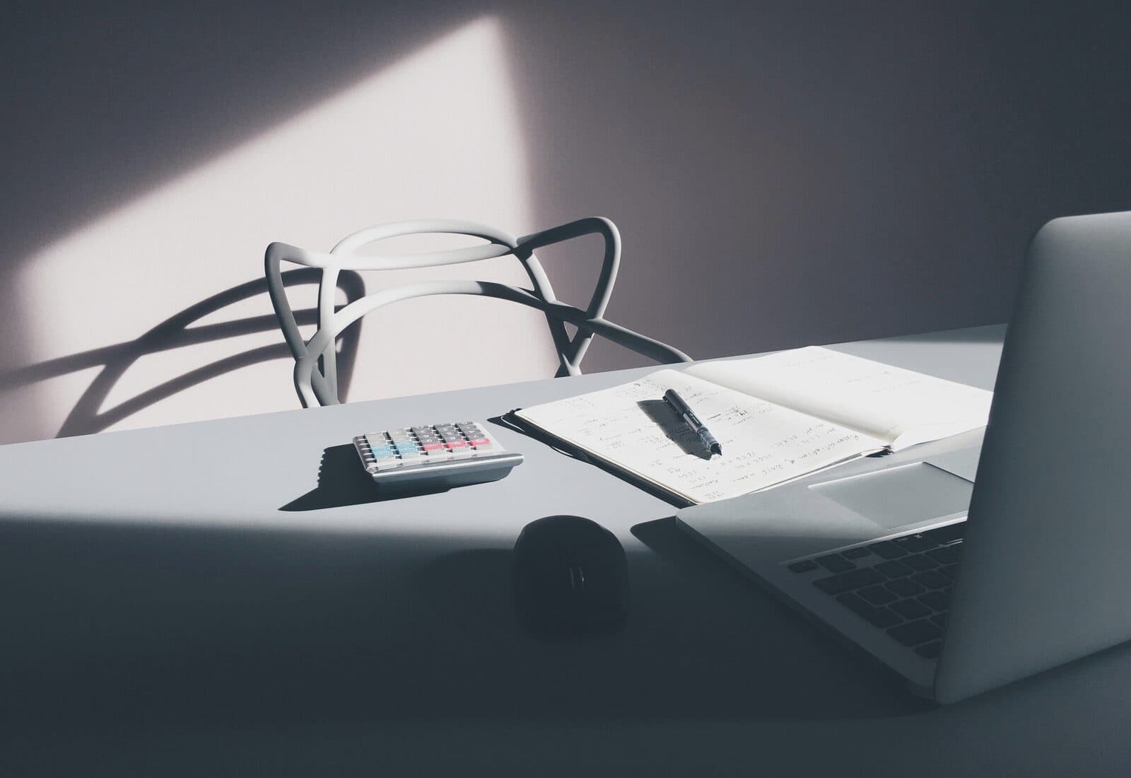 Calculator and laptop arranged for financial planning